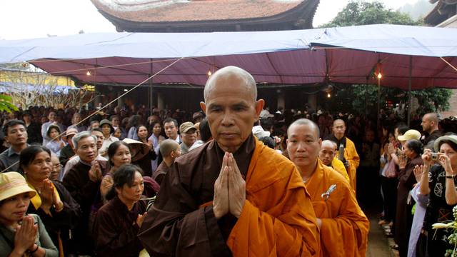 FILE PHOTO: Buddhist monk Nhat Hanh walks among believers at a requiem mass at the Non Nuoc pagoda outside Hanoi