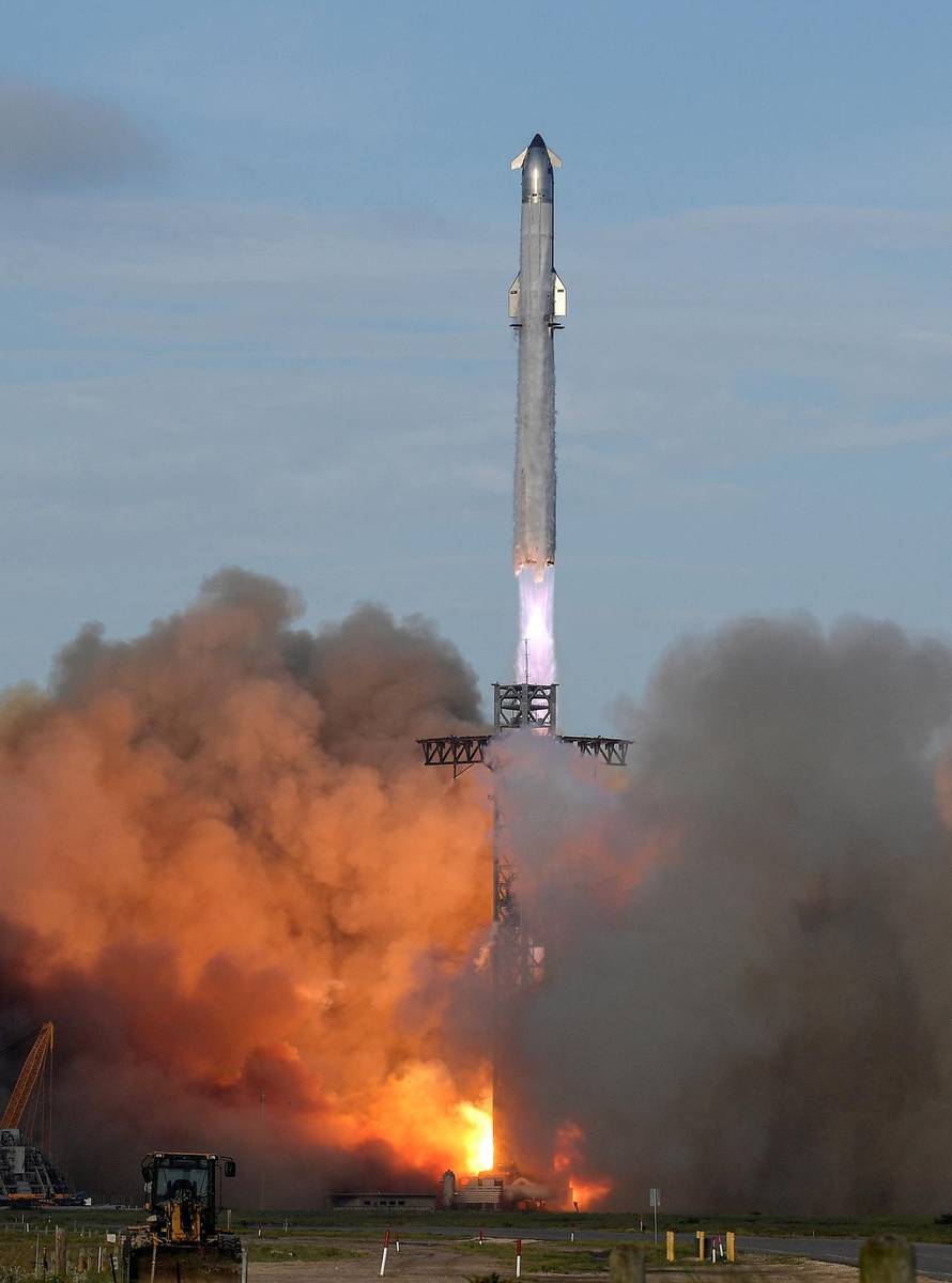 A SpaceX Super Heavy booster carrying the Starship spacecraft lifts off on its 10th test flight