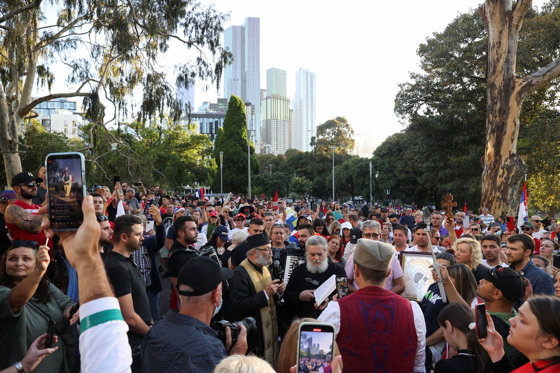 Supporters gather outside the hotel where Novak Djokovic is believed to be held in Melbourne