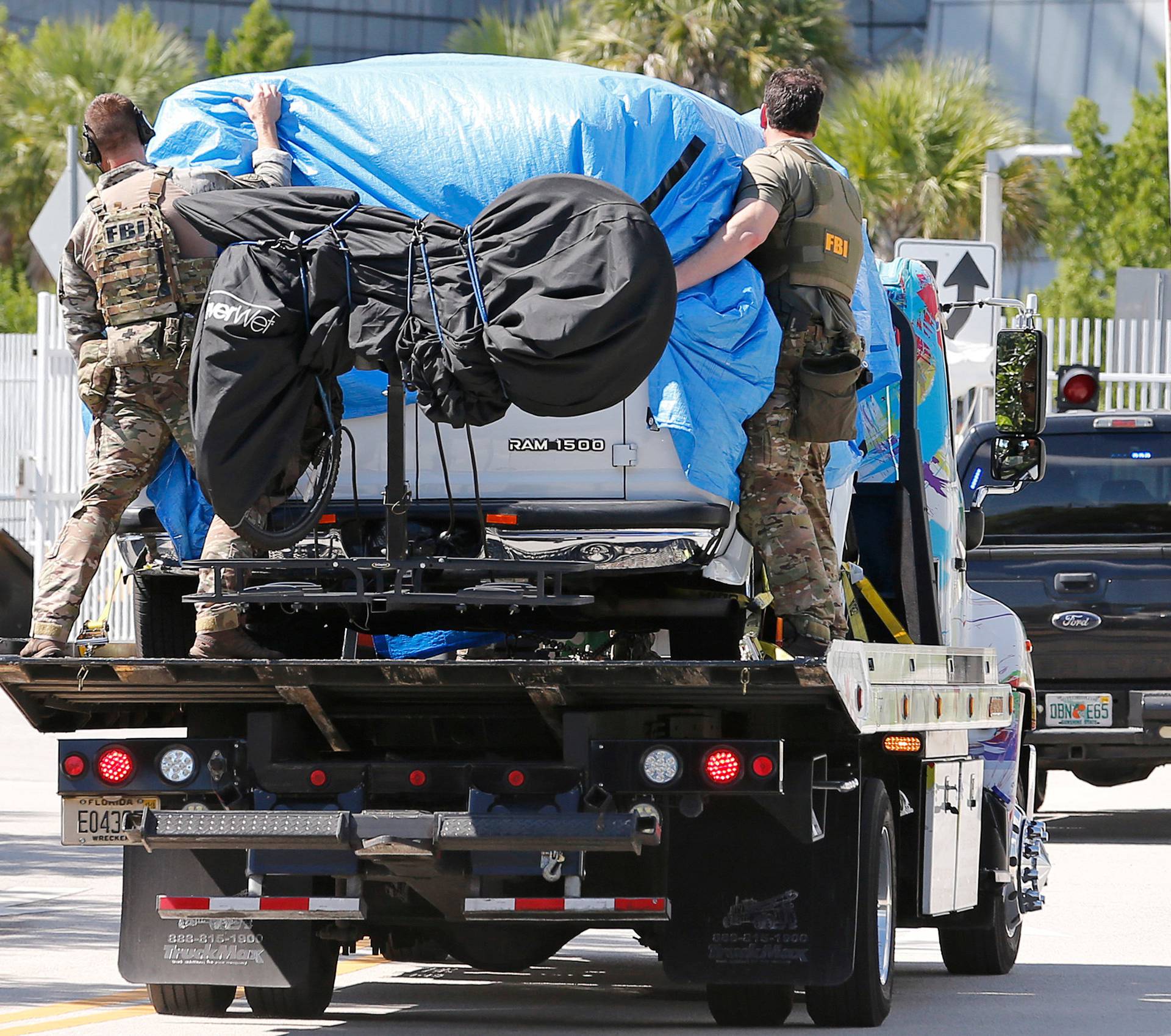 A white van is towed into FBI headquarters in Miramar