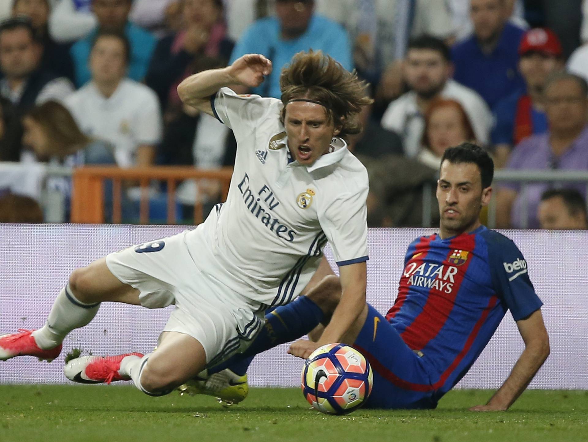 Real Madrid's Luka Modric in action with Barcelona's Sergio Busquets