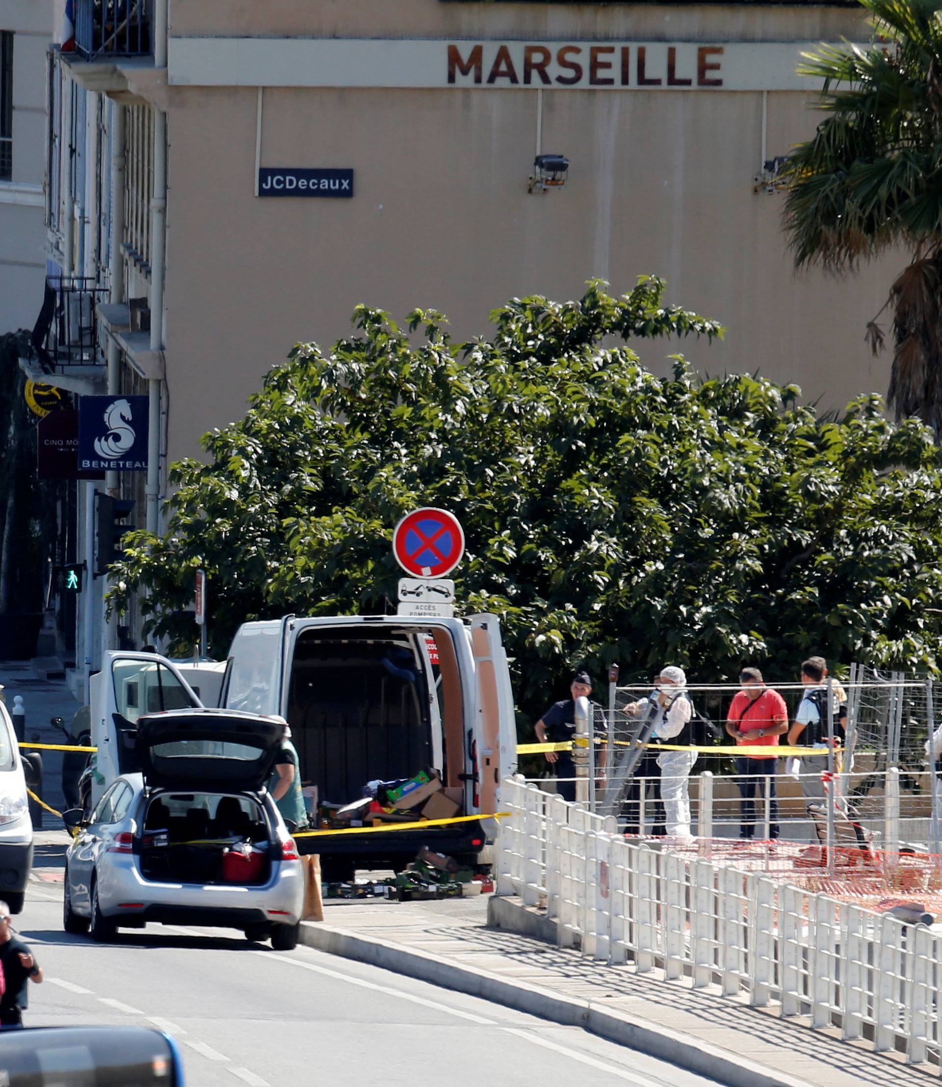 French police conduct their investigatation in the French port city of Marseille after one person was killed and another injured after a vehicle crashed into two bus shelters