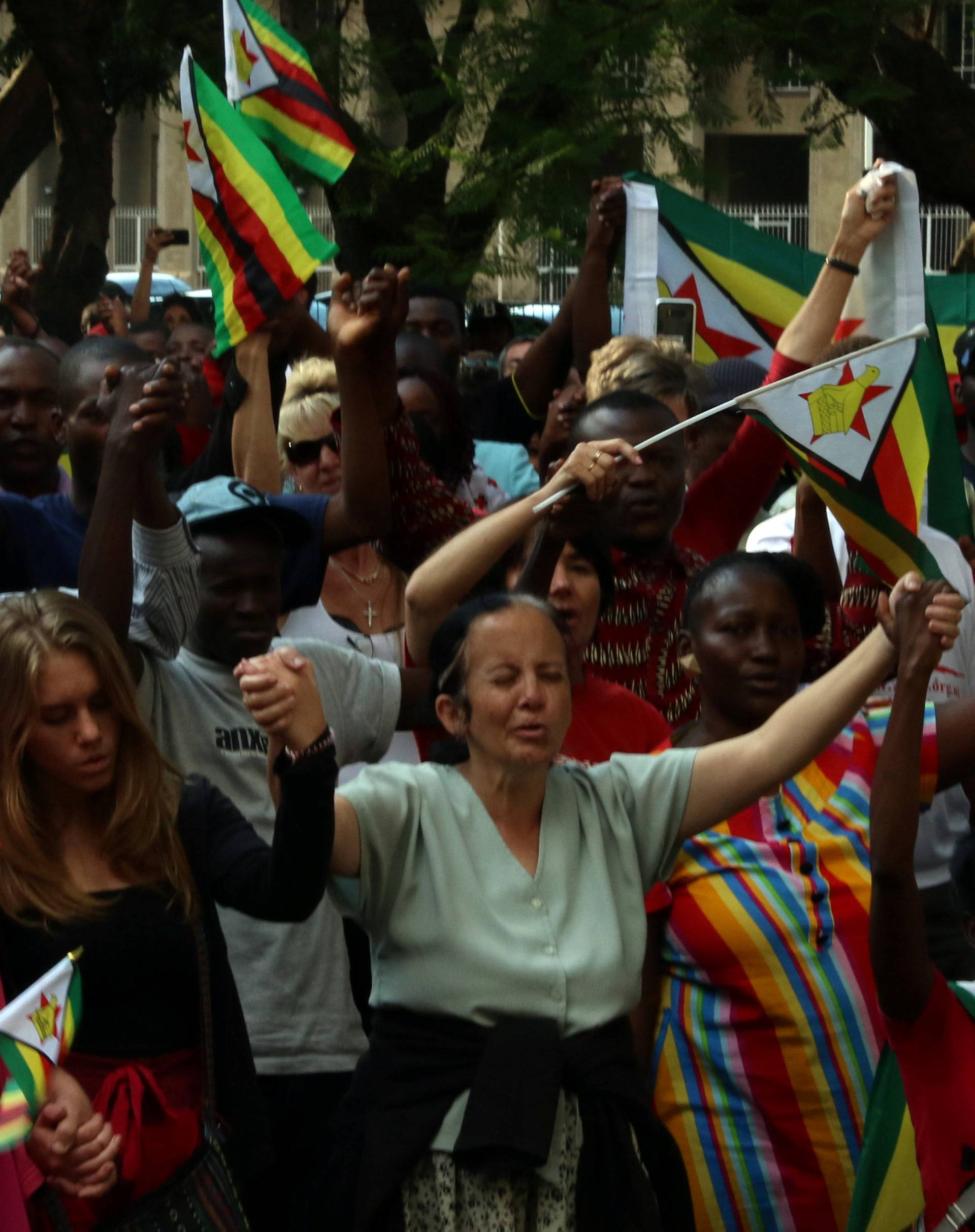 Residents attend a prayer meeting called to celebrate after Zimbabwean President Robert Mugabe was dismissed as party leader of the ruling ZANU-PF's central committee in Harare