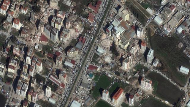 A satellite image shows collapsed buildings and traffic after an earthquake in Antakya