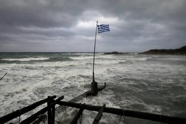 A Greek flag flatters in a beach near the town of Kyllini, as rare storm, known as a Medicane (Mediterranean hurricane), hit western Greece