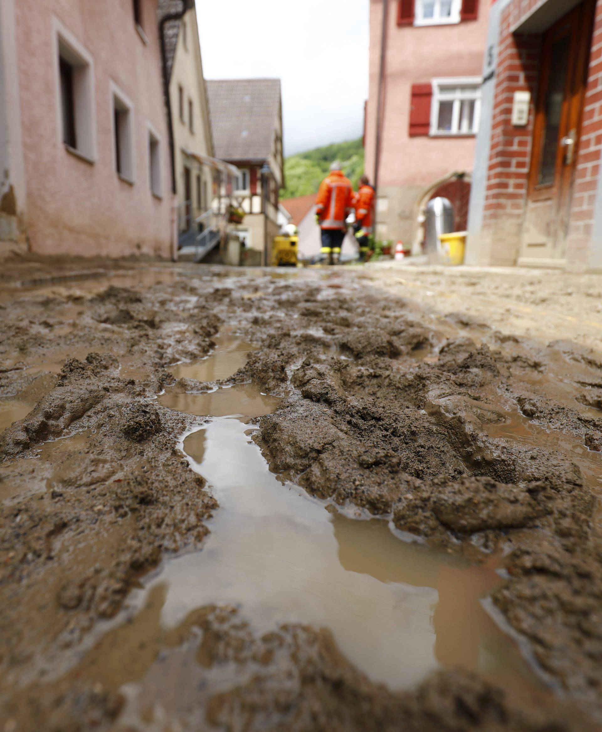 A mud covered street is pictured after the floods in the town of Braunsbach