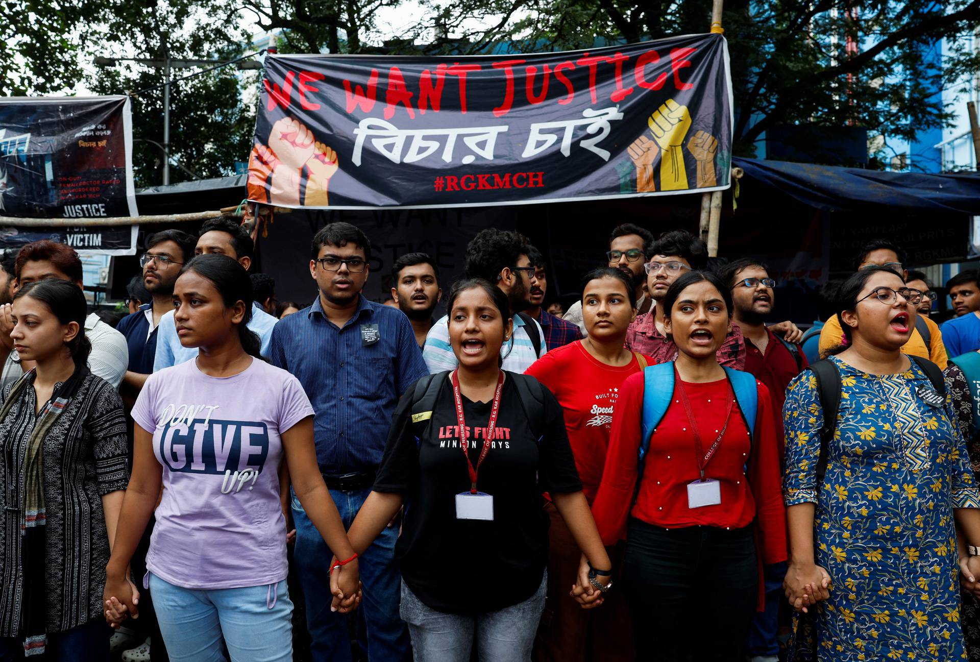 Medical students hold hands as they attend a protest against what they say was rape and murder of a trainee doctor, inside the premises of R G Kar Medical College and Hospital in Kolkata