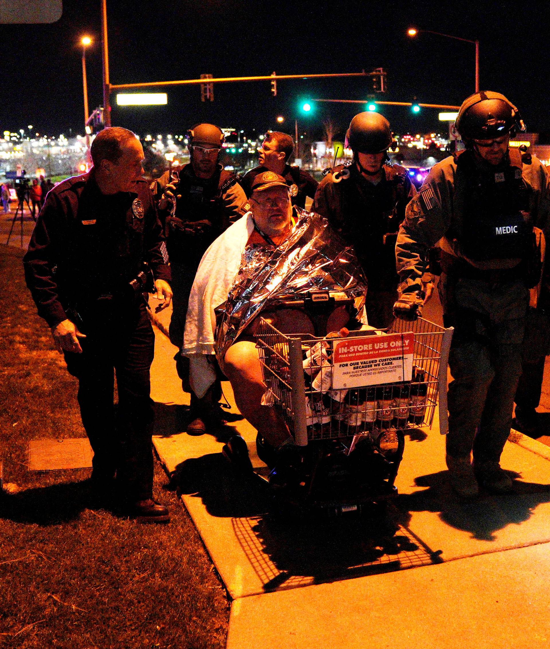 Patrick Carnes is evacuated in a Walmart cart by SWAT medics from the scene of a shooting at a Walmart where Carnes was shopping in Thornton