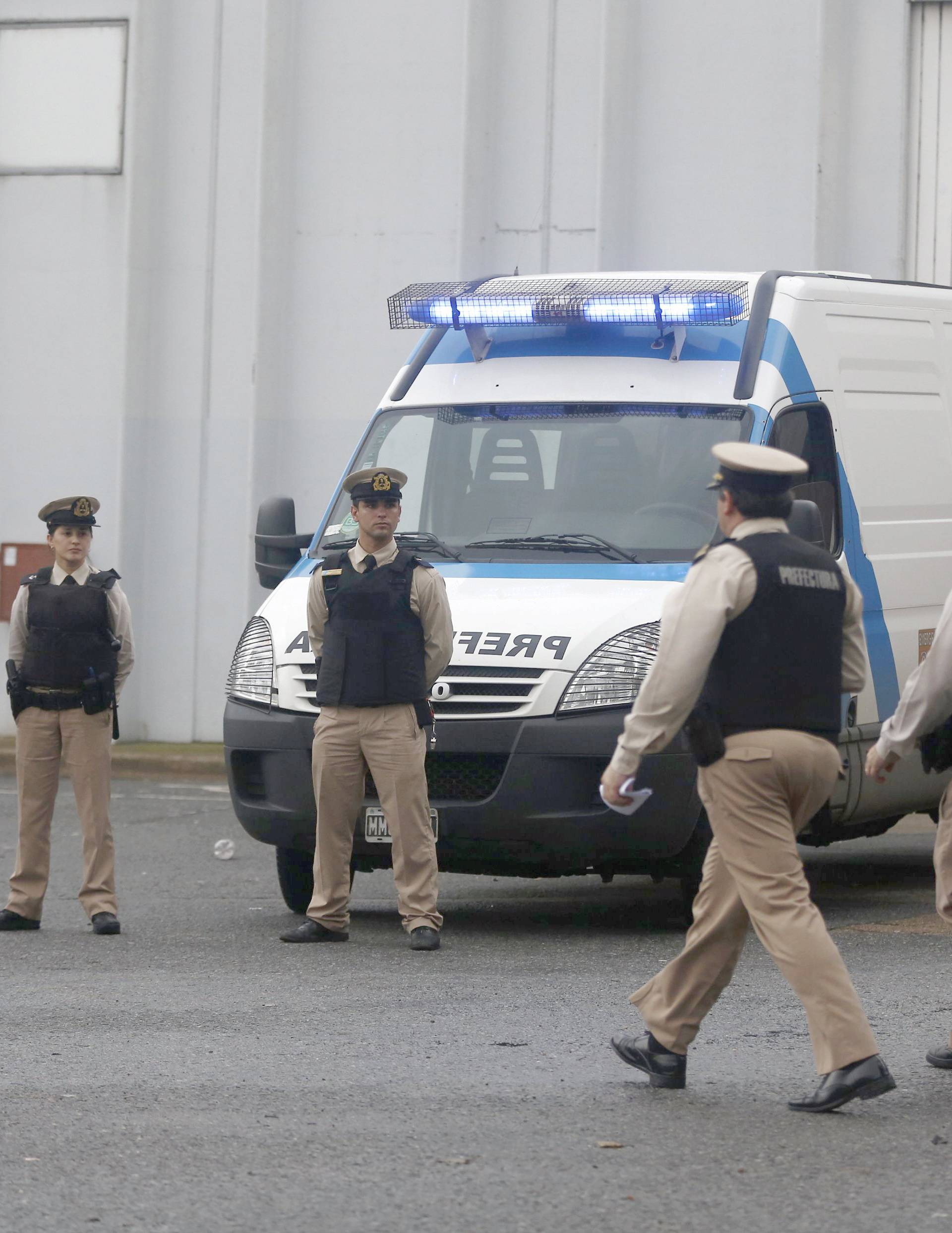 Officers from the Coast Guard walk by the area where five people died and several others were hospitalized during an electronic music part in Buenos Aires