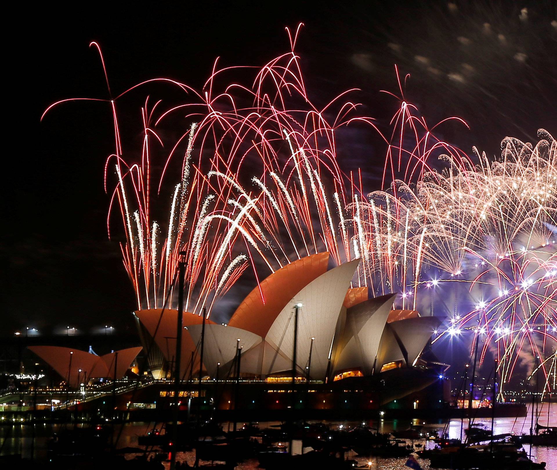 Fireworks explode over the Sydney Opera House and Harbour Bridge as Australia ushers in the New Year in Sydney