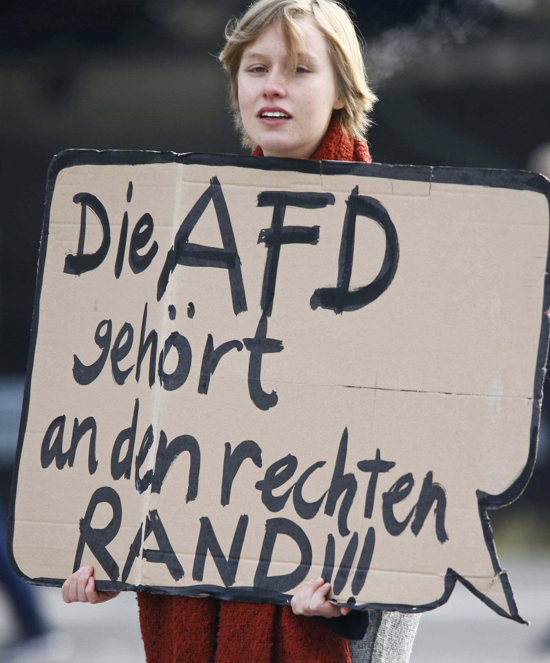 Anti-AfD protestor holds a banner reading 'Afd belongs to the right border' during the AfD party congress in Stuttgart