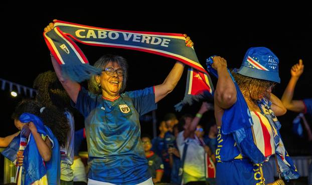 Fans of the Cape Verde national soccer team celebrate as they watch a World Cup group stage match against Uruguay in Praia