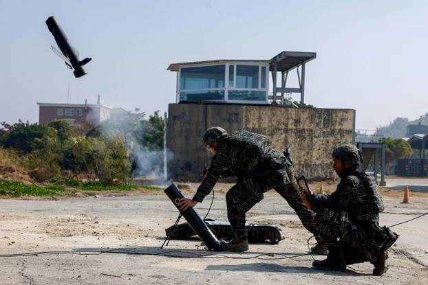 FILE PHOTO: Soldiers operate a Taiwan-made attack drone during an annual military exercise ahead of the Lunar New Year in Kaohsiung