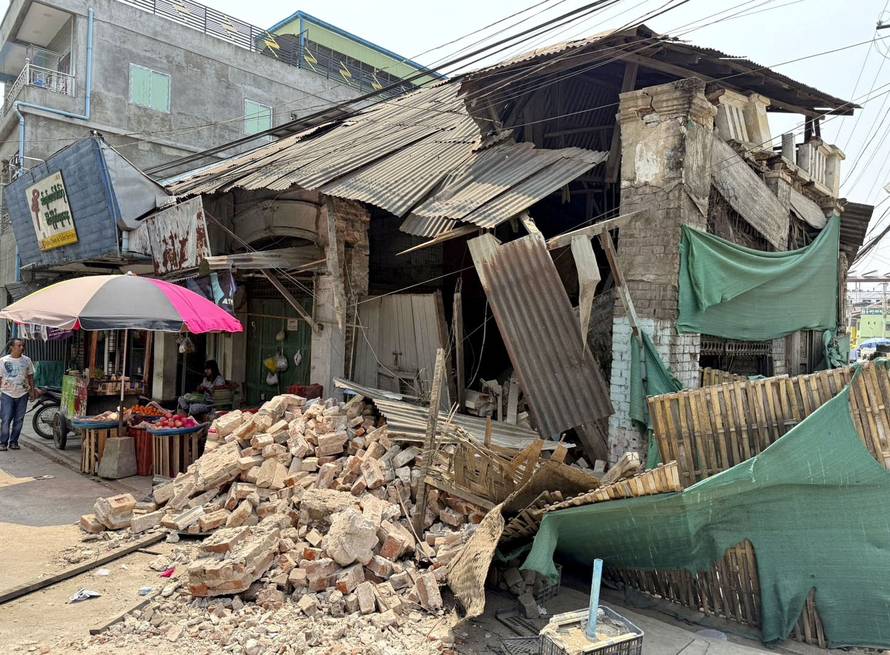 Rubble lies in front of a shop damaged by an earthquake in Taungoo