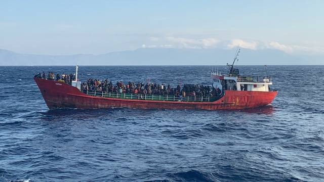 FILE PHOTO: Cargo ship carries migrants during a rescue operation, as it sails off the island of Crete