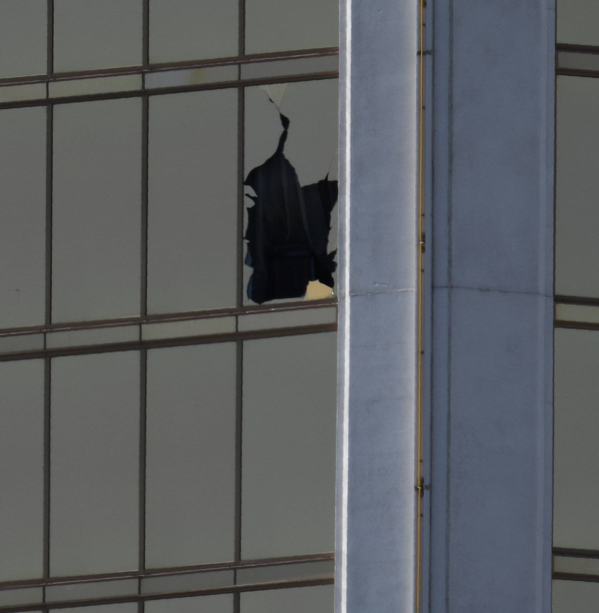 A broken window is seen at The Mandalay Bay Resort and Casino following a mass shooting at the Route 91 Festival in Las Vegas