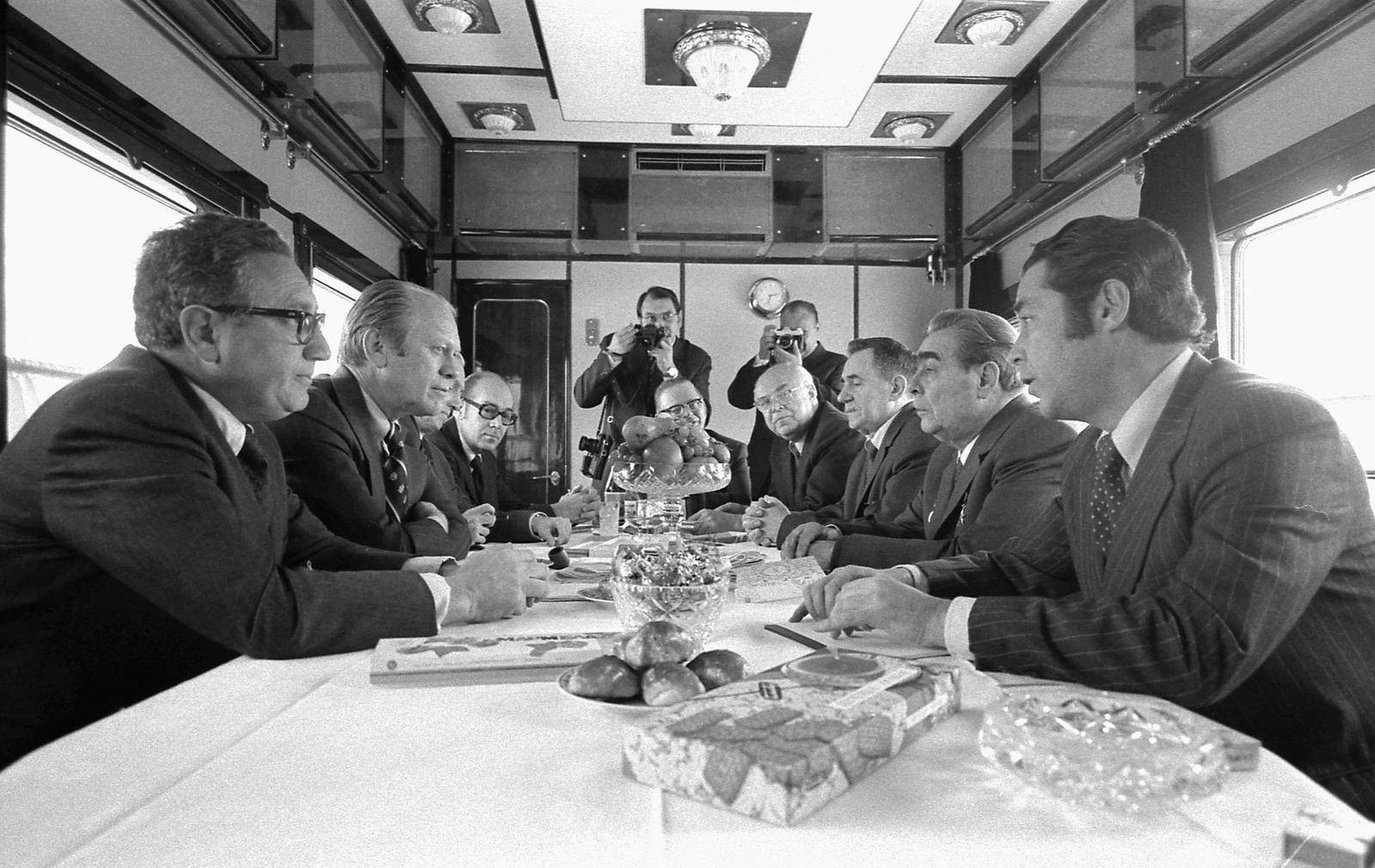 U.S. President Gerald Ford, Secretary of State Henry Kissinger and other U.S. representatives meet with Soviet General Secretary Brezhnev, Foreign Secretary Gromyko, Ambassador Dobrynin, and others aboard a Russian train headed for Vladivostok