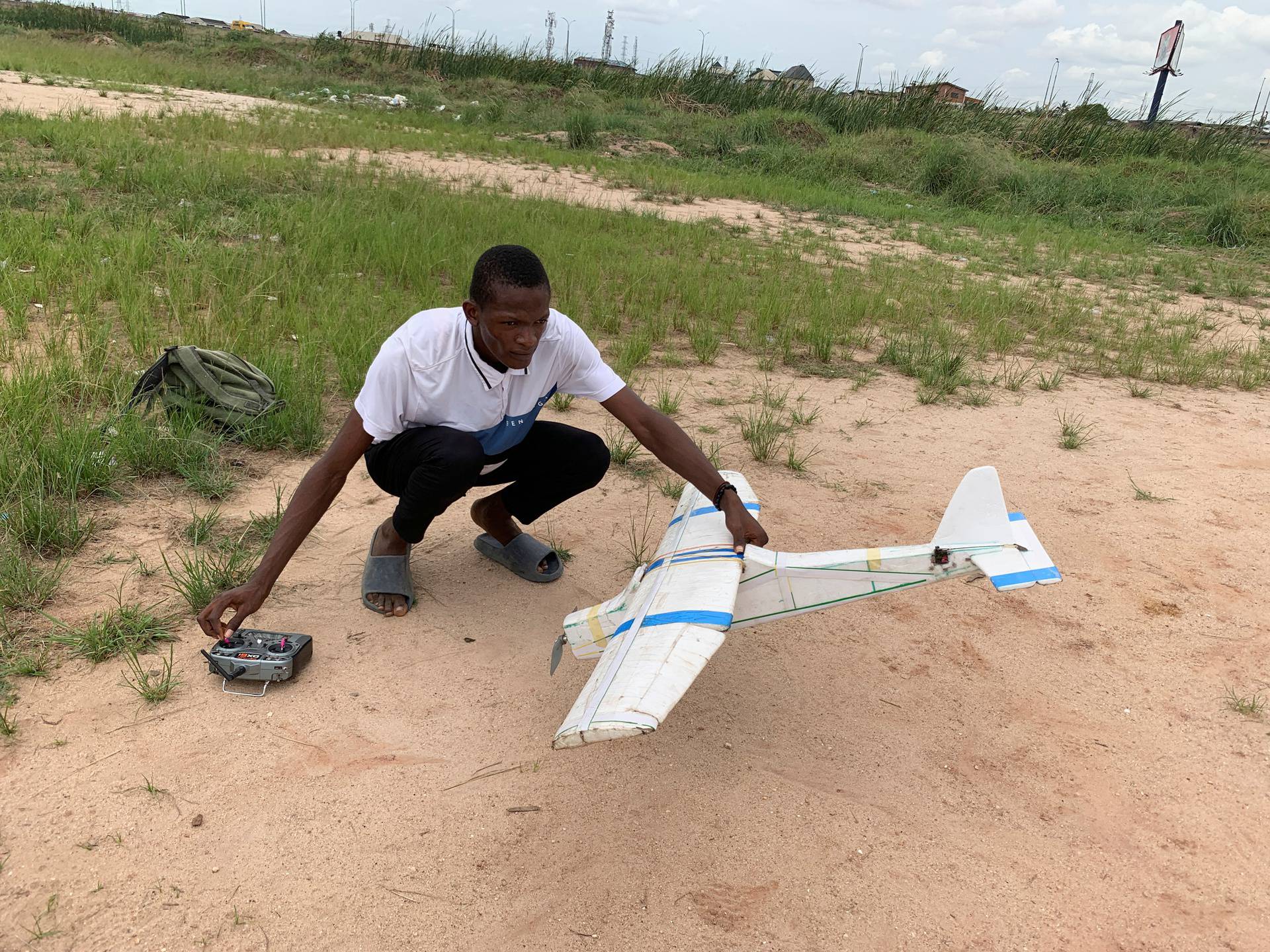 Bolaji Fatai prepares to fly a model aeroplane made from discarded waste in Lagos