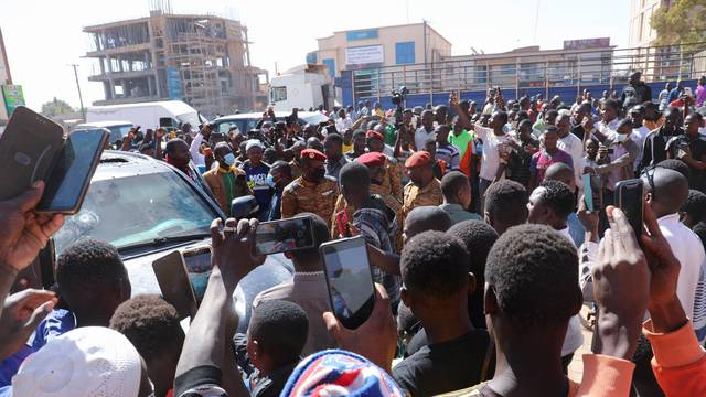 People gather after Burkina Faso President Roch Kabore was detained at a military camp following heavy gunfire near the president's residence in Ouagadougou