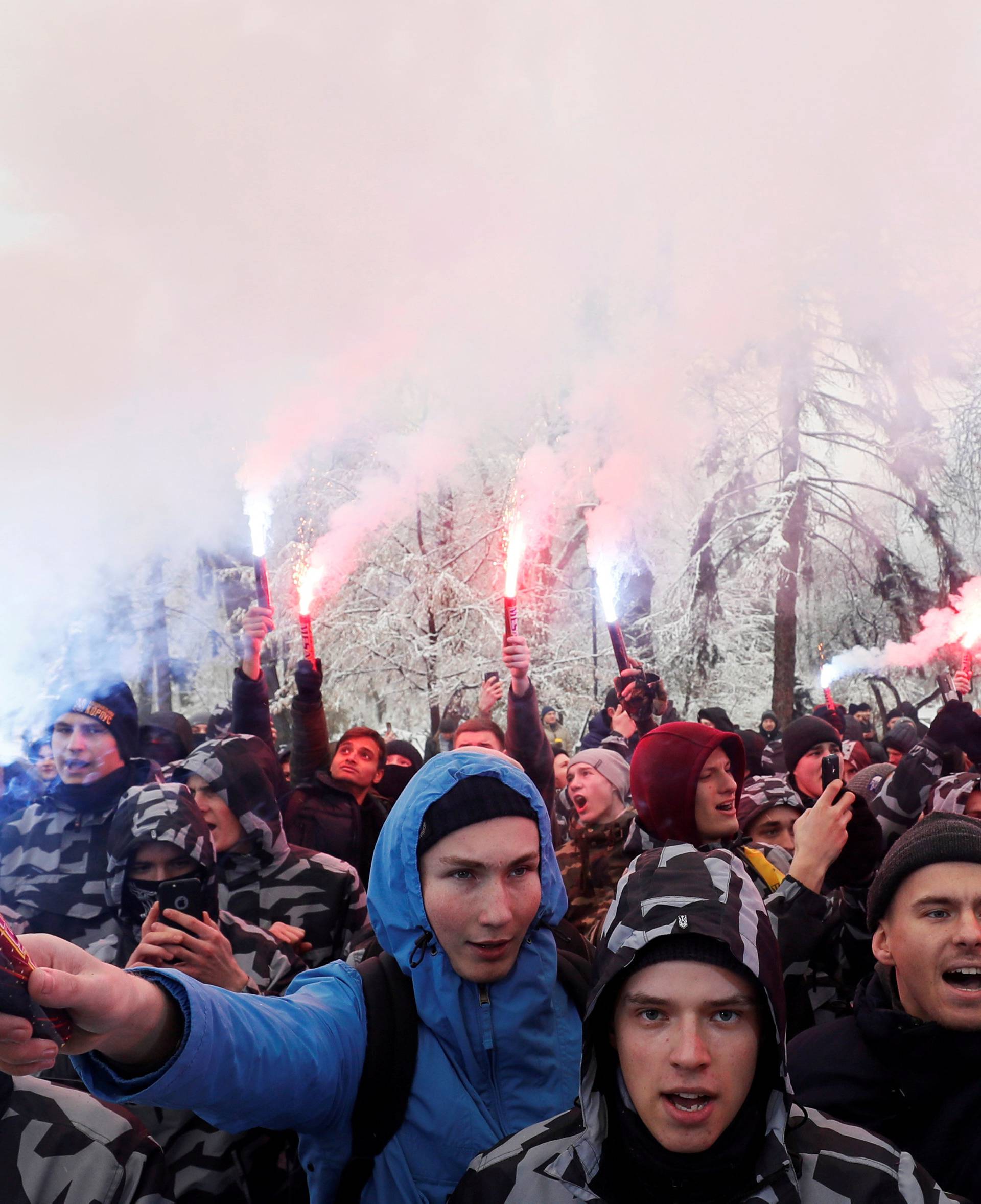 Activists of far-right parties burn flares during a rally to support the Ukrainian navy after Russia seized two Ukrainian armored artillery vessels and a tug boat in the Black Sea, in front of the presidential administration headquarters in Kiev