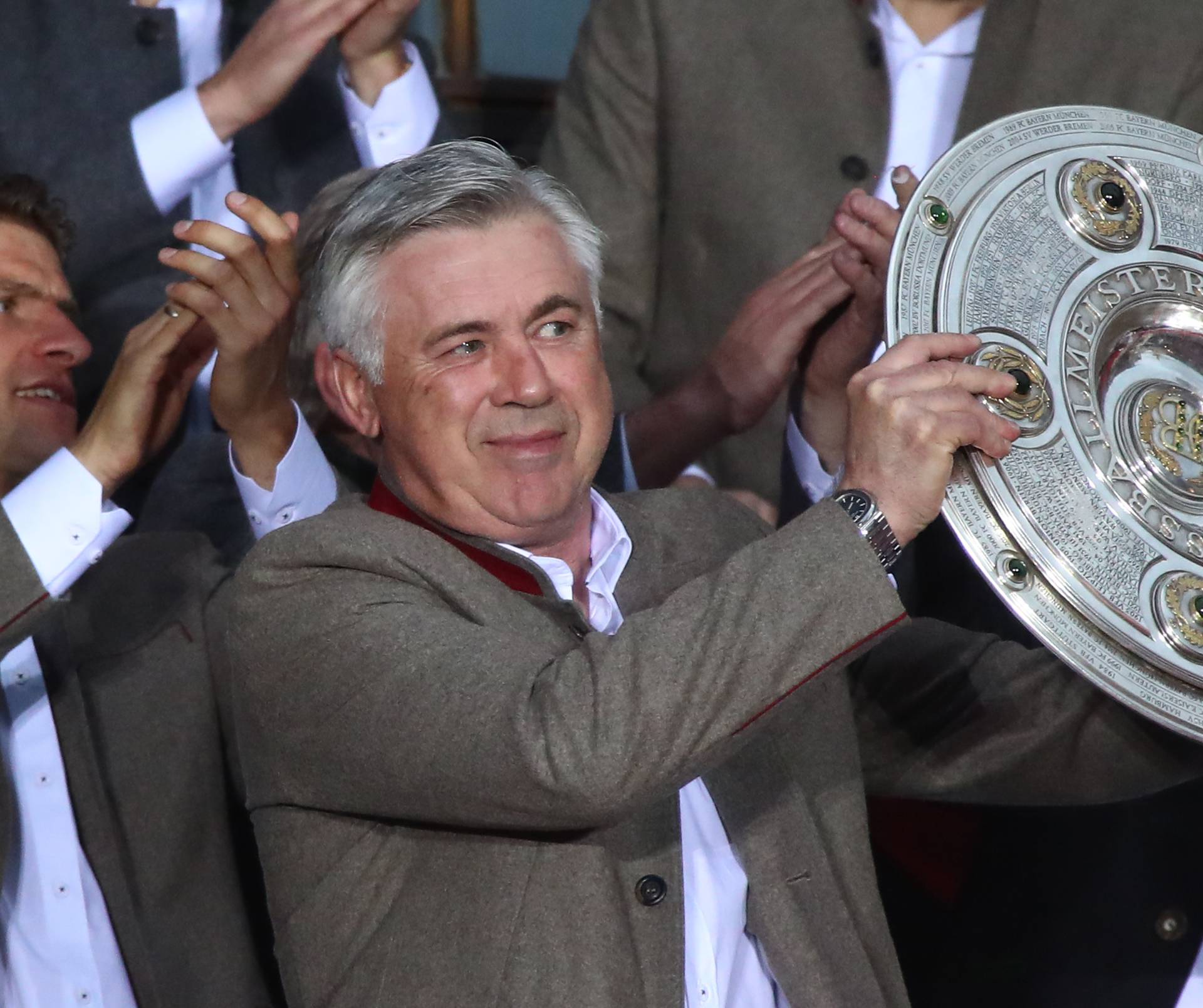 Bayern Munich coach Carlo Ancelotti celebrates with the trophy  during the presentation