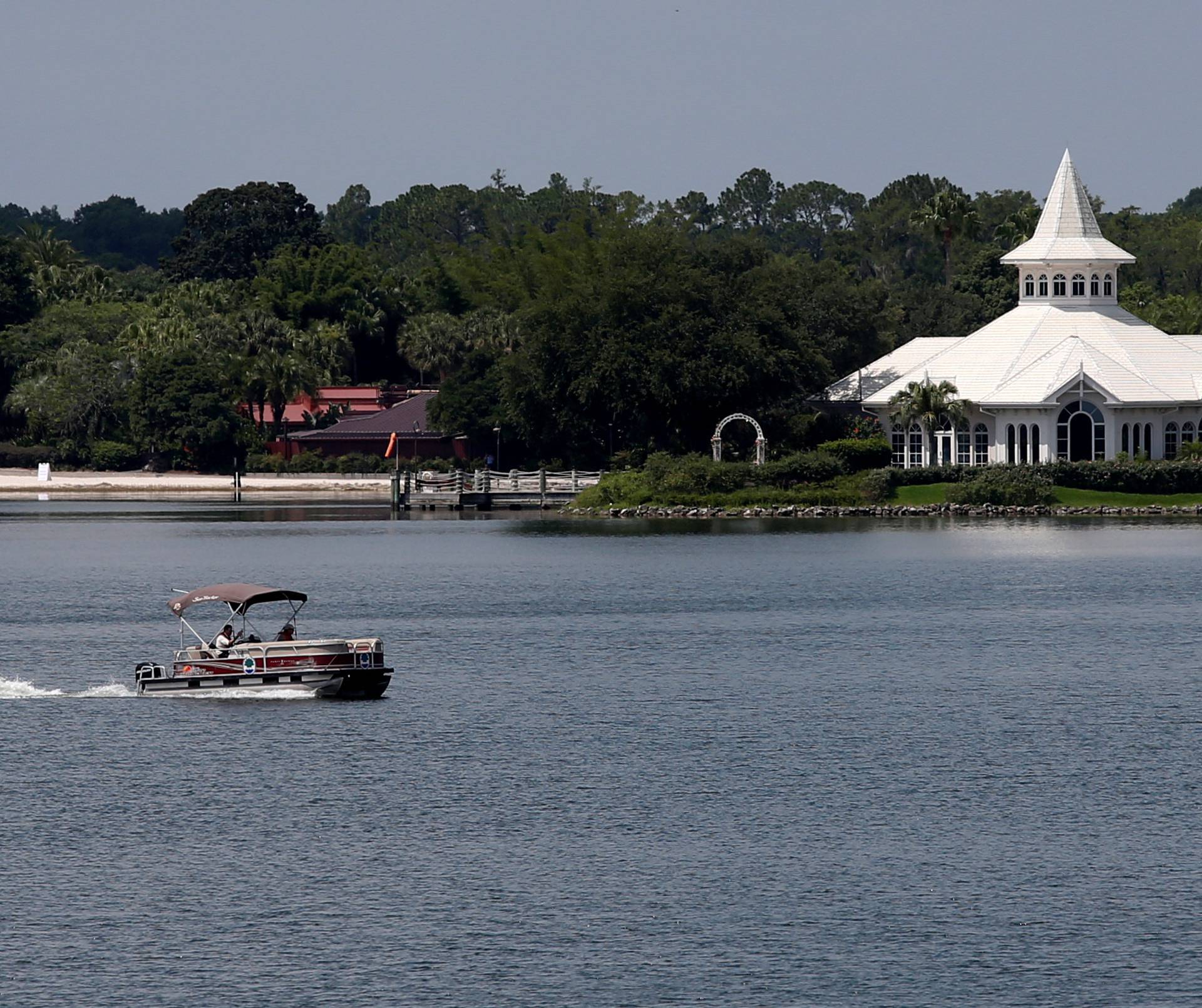 A search boat is seen in the Seven Seas Lagoon, in front of a beach at the Grand Floridian, at the Walt Disney World resort in Orlando, Florida
