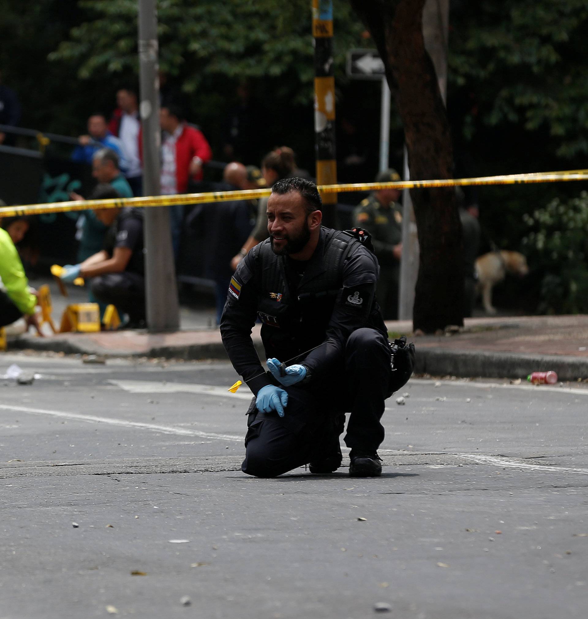 A police officer works the scene where an explosion occurred near Bogota's bullring