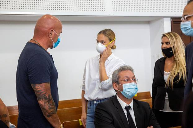 Israeli model Bar Refaeli wears a face mask as she arrives for a hearing in the tax evasion case against her and her mother Tzipi, at a court in Tel Aviv, Israel