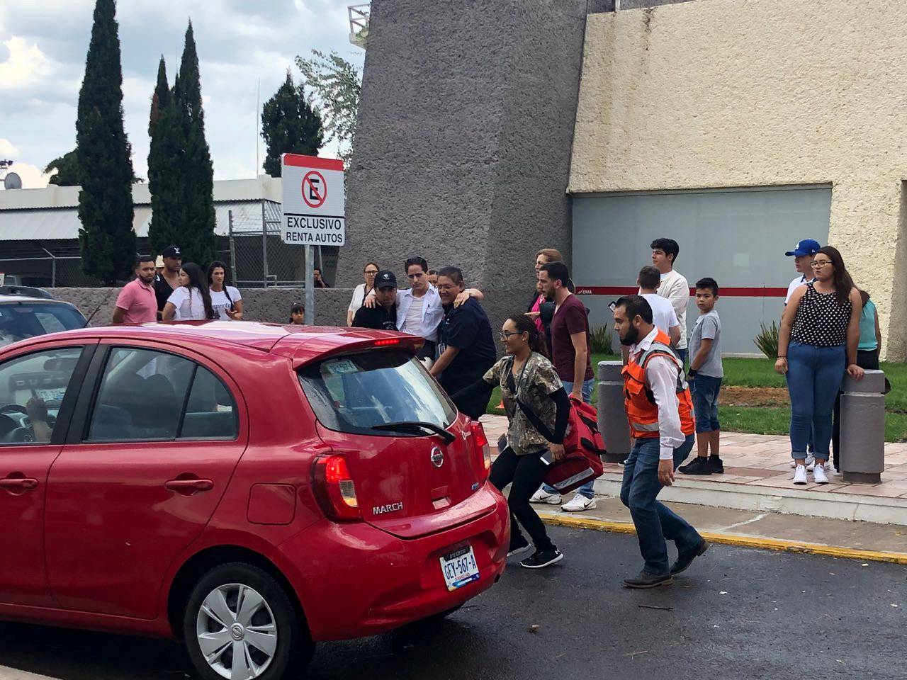 A man is helped into a car outside the Durango Airport after an Aeromexico-operated Embraer passenger jet crashed right after takeoff in Mexico's state of Durango
