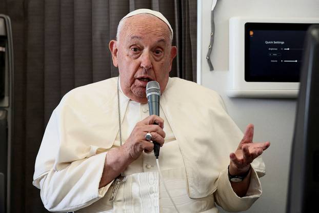 FILE PHOTO: Pope Francis holds a news conference aboard the papal plane