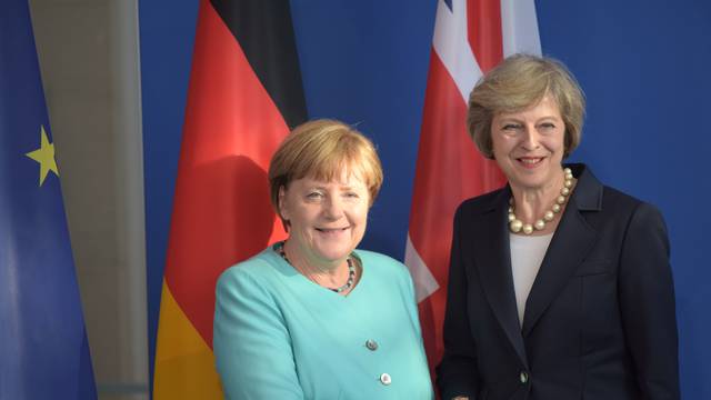 German Chancellor Merkel and British Prime Minister May shake hands after news conference in Berlin