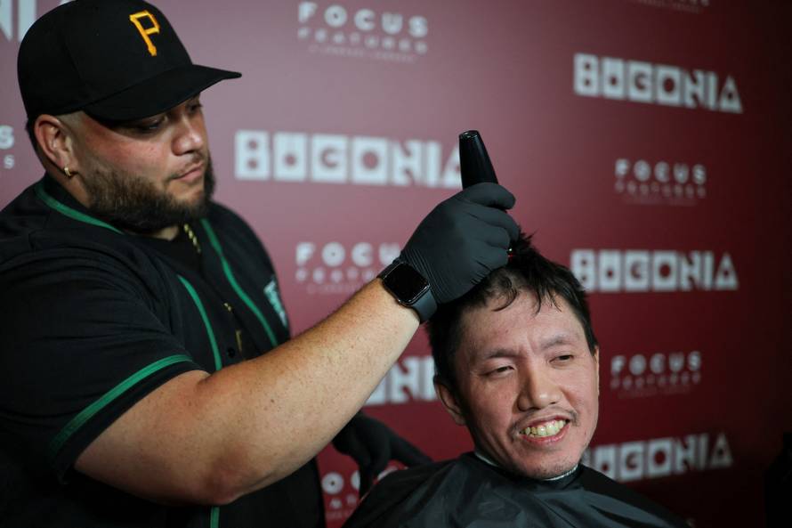 A fan gets his head shaved for a free preview of Yorgos Lanthimos’s new film 'Bugonia', in California