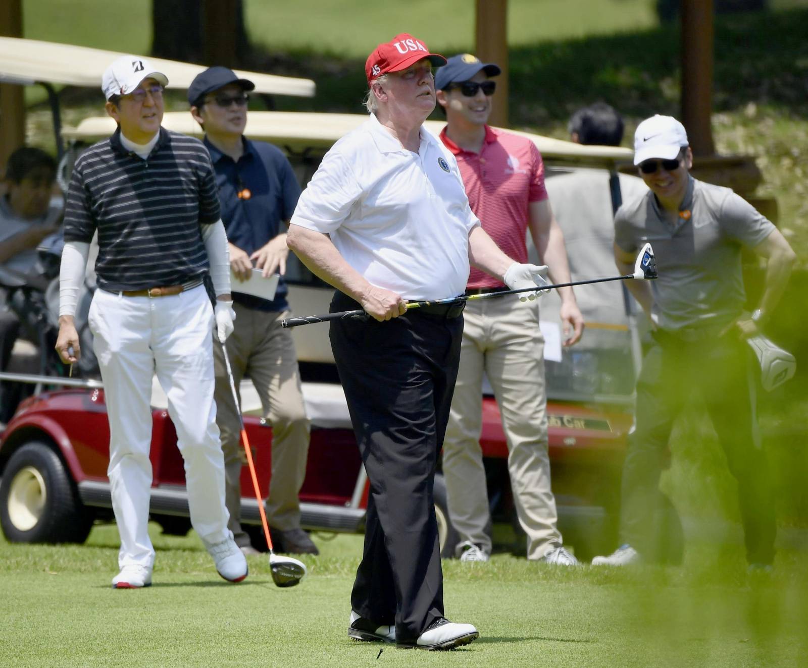 U.S. President Donald Trump and Japan's Prime Minister Shinzo Abe play golf at Mobara Country Club in Mobara, Chiba prefecture, Japan