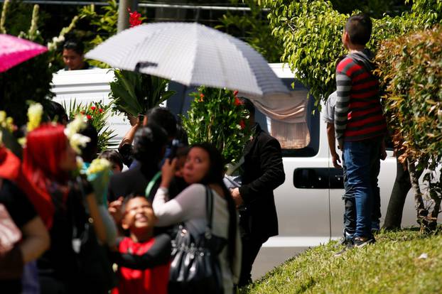 Family and friends participate in the funeral of Oscar Alberto Martinez Ramirez and his daughter Valeria, migrants who drowned in the Rio Grande river during their journey to the U.S., at La Bermeja cemetery in San Salvador