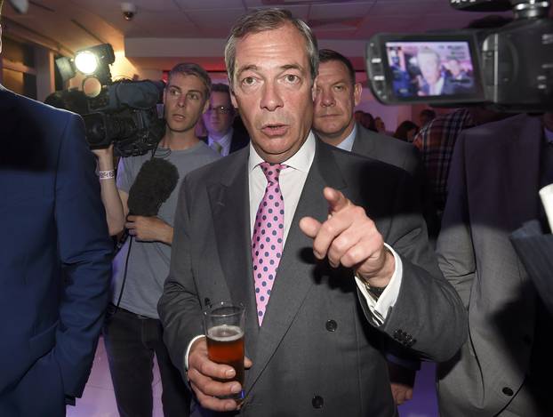 Nigel Farage, the leader of the United Kingdom Independence Party (UKIP), holds a drink at a Leave.eu party after polling stations closed in the Referendum on the European Union in London