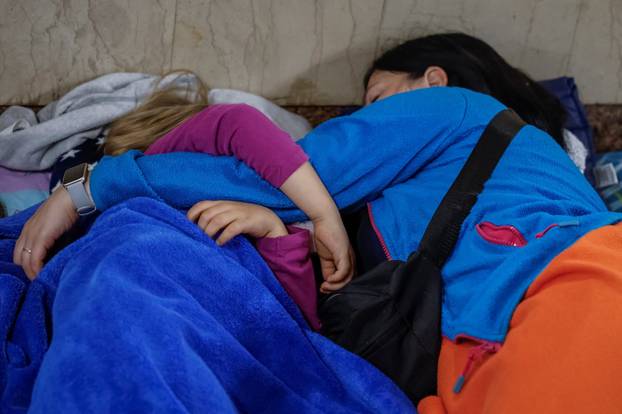 People take shelter inside a metro station during an air raid alert in Kyiv