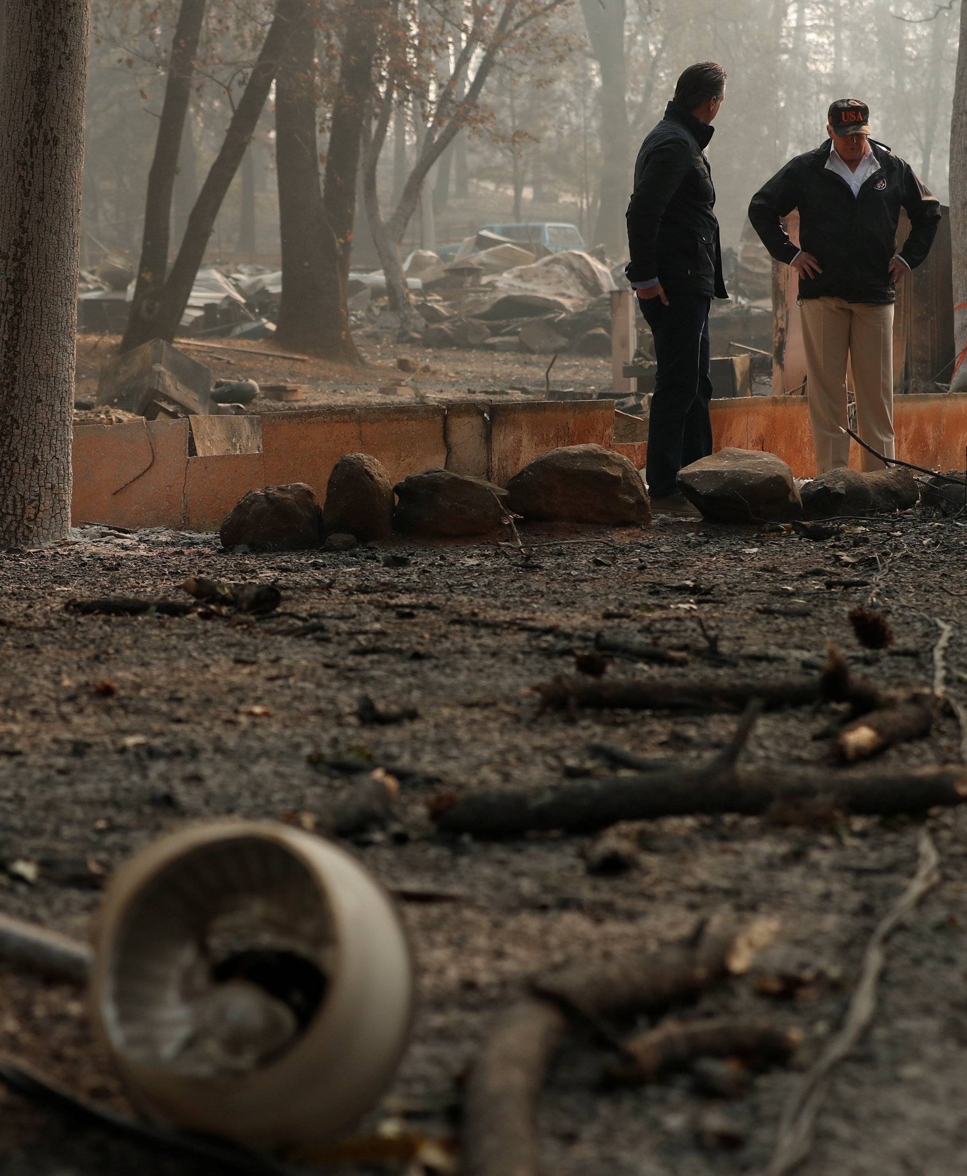 President Donald Trump visits the charred wreckage of Skyway Villa Mobile Home and RV Park with Governor-elect Gavin Newsom Brock Long Paradise Mayor Jody Jones and Governor Jerry Brown in Paradise California