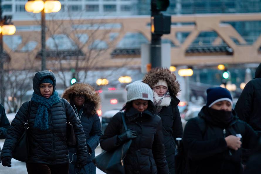 Pedestrians cross the street at rush hour as bitter cold phenomenon called the polar vortex has descended on much of the central and eastern United States