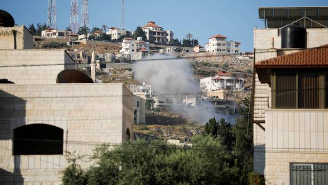 Palestinians clash with Israeli troops during an Israeli raid in Jenin