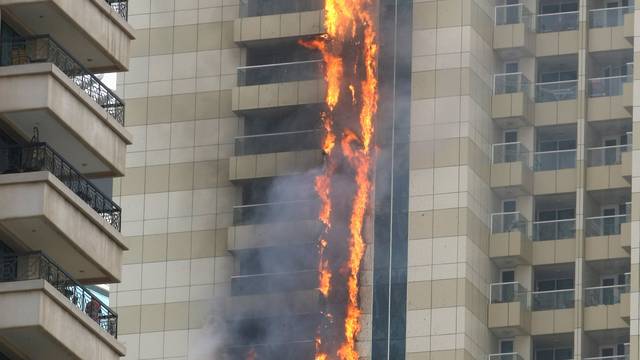 Flames are seeen after a fire broke out at residential Sulafa tower in the upscale Marina district in Dubai 
