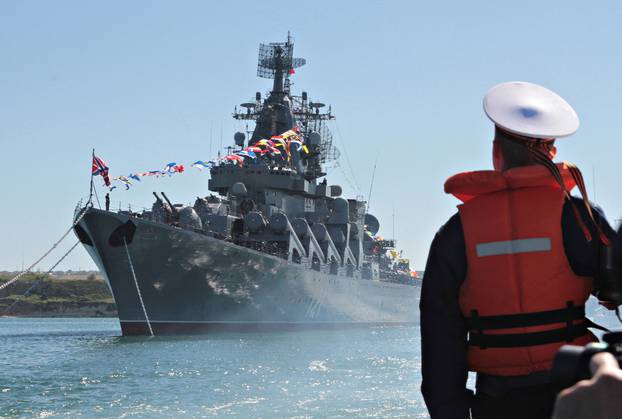 FILE PHOTO: A sailor looks at the Russian missile cruiser Moskva moored in the Ukrainian Black Sea port of Sevastopol