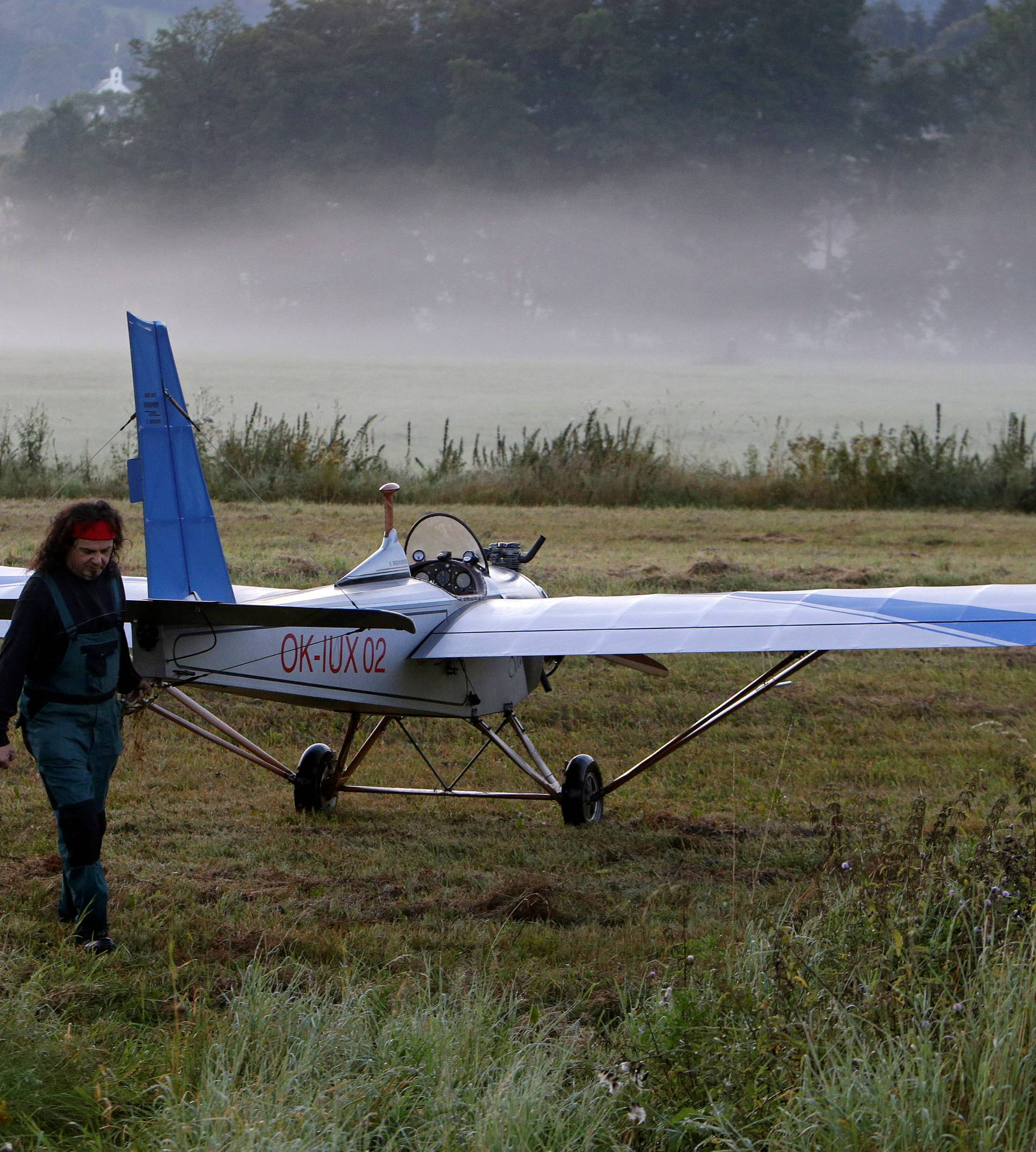 Aviator Frantisek Hadrava pulls Vampira, an ultralight plane based on the U.S.-design of light planes called Mini-Max, on a field near the town of Ckyne
