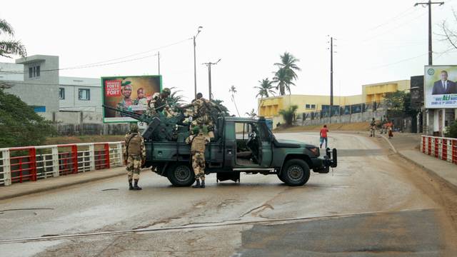Soldiers of the Republican Guard stand on their armed pick-up in a street in Libreville