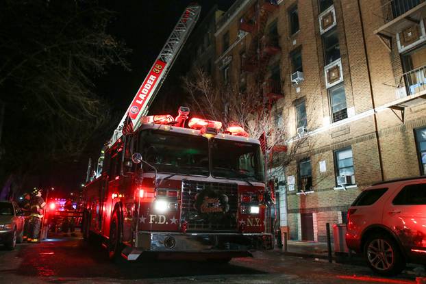FDNY personnel work on the scene of an apartment fire in New York