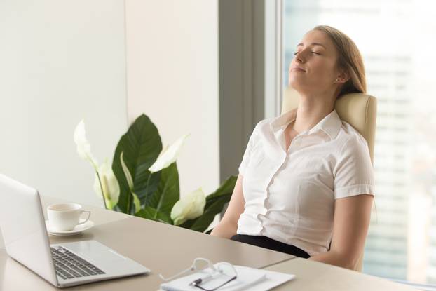 Businesswoman takes short time-out in office work