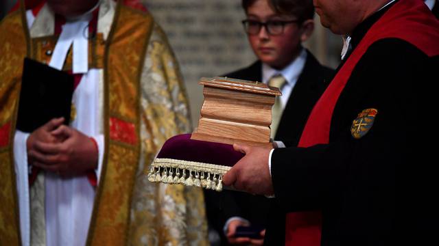 The ashes of British scientist Stephen Hawking are held at the site of interment in the nave of the Abbey church, during a memorial service at Westminster Abbey, in London