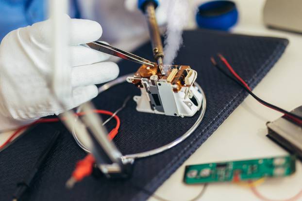 Man hold tool repairs electronics manufacturing Services, Manual