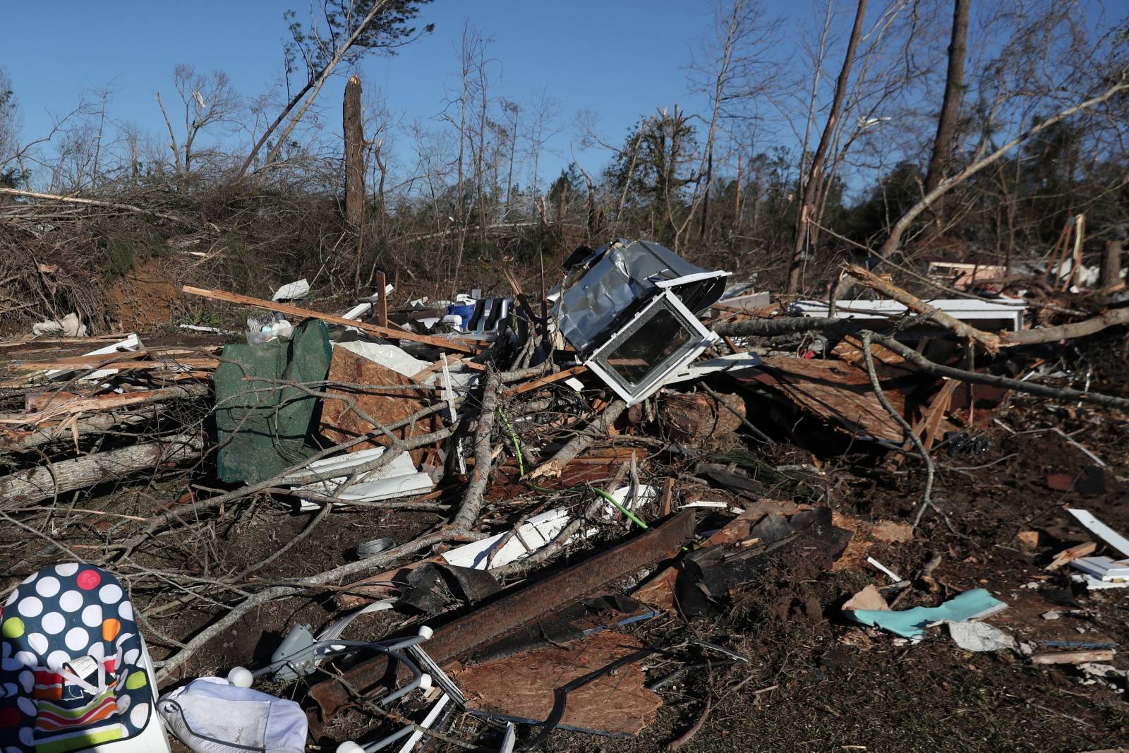 Debris lays outside a house devastated after two deadly back-to-back tornadoes, in Beauregard, Alabama