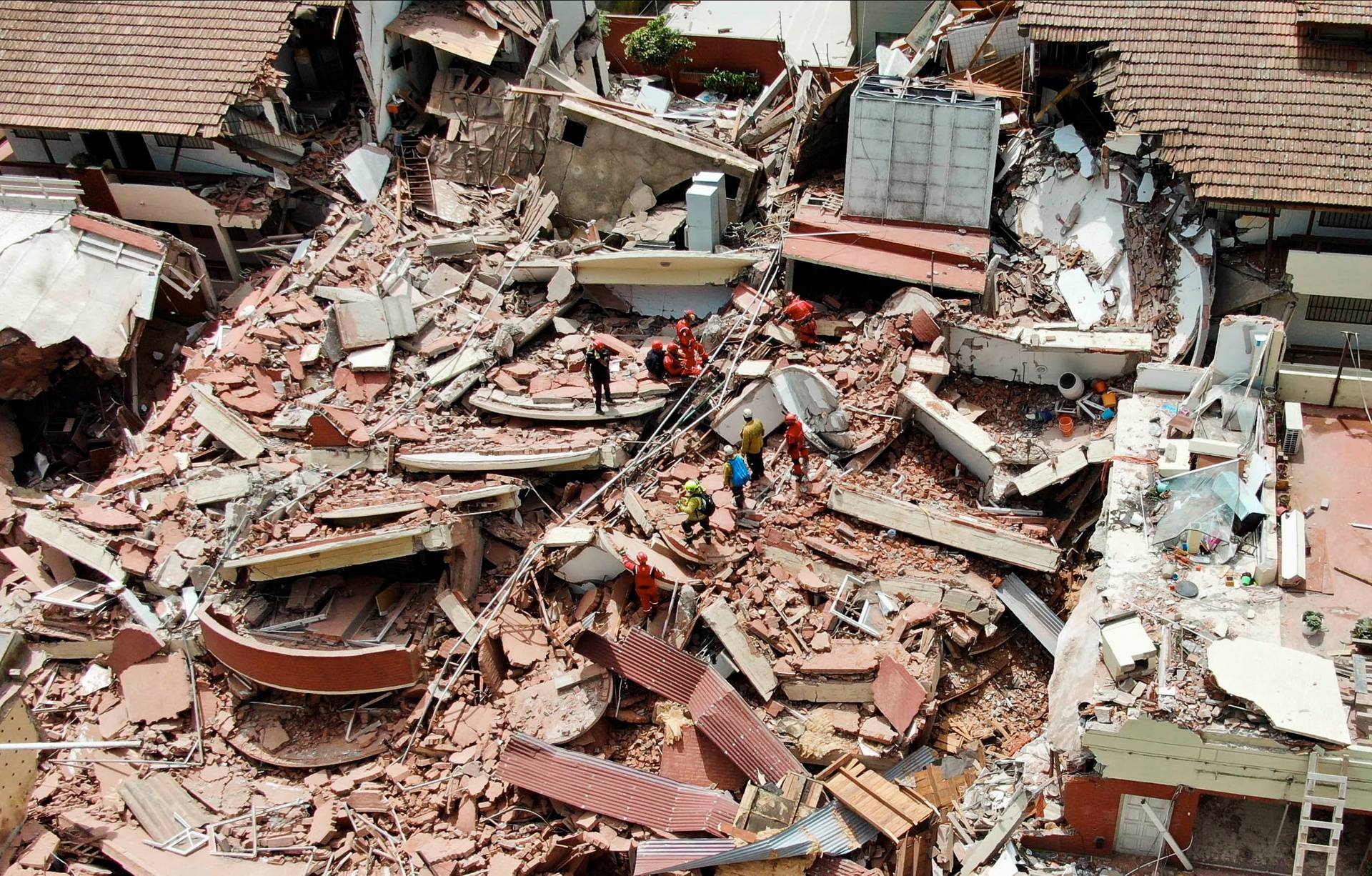 Firefighters search for trapped people after a hotel collapses in Villa Gesell