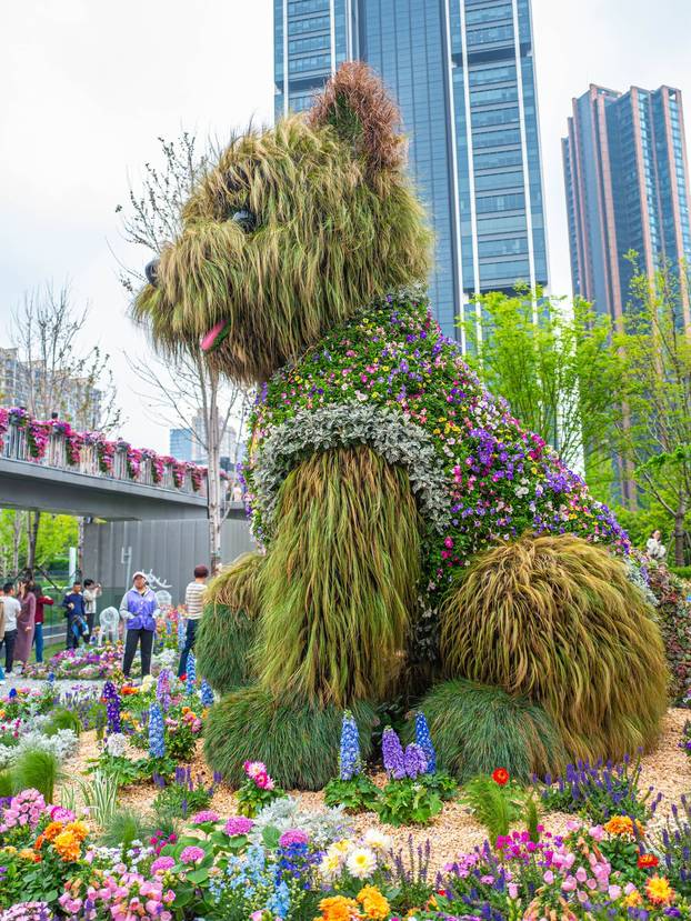 SHANGHAI, CHINA - APRIL 19: A 5.2-meter-tall puppy made of flowers and greenery steals the spotlight at the ongoing 2026